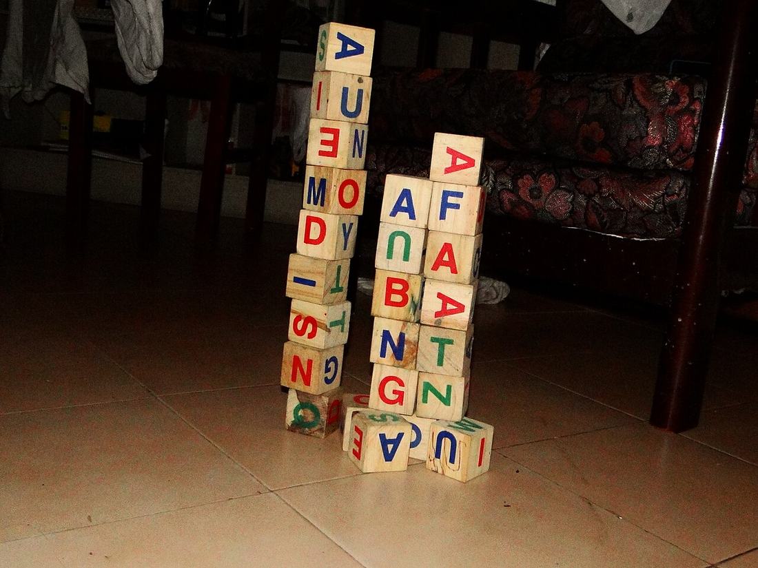 A pile of wooden alphabet blocks