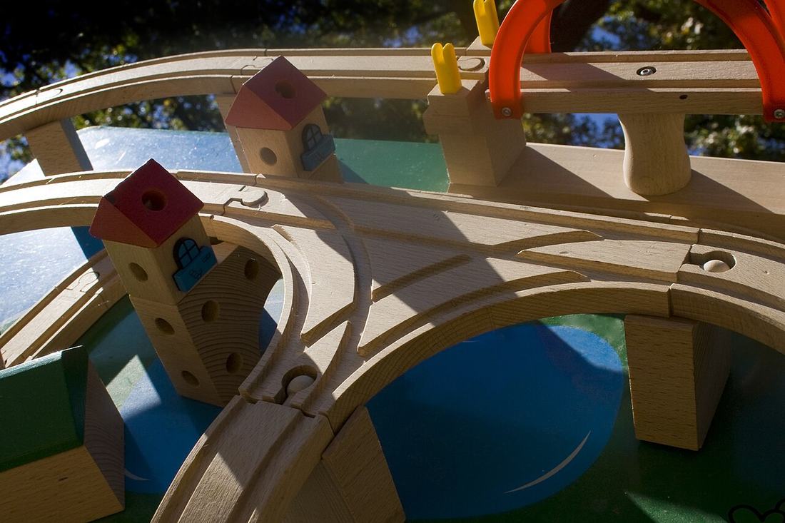 A wooden toy train on tracks